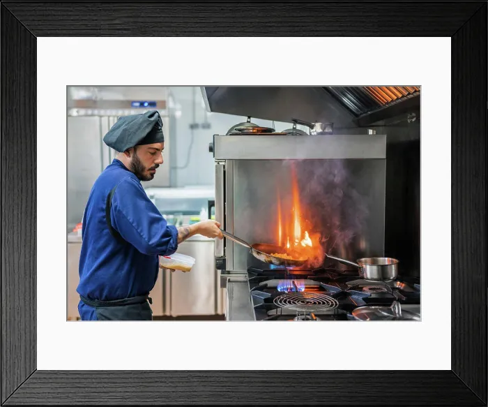 Framed Print : Chef cooking with flame in frying pan Framed Print : Chef cooking with flame in frying pan