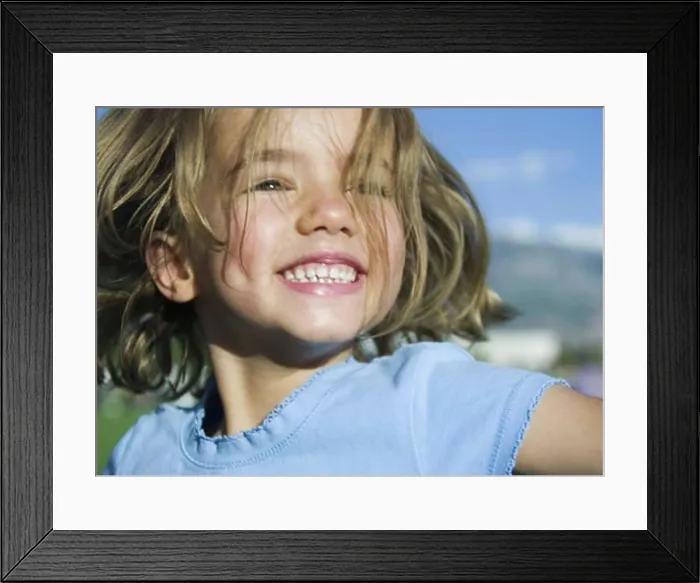 Framed Print : Close-up of a girl smiling Framed Print : Close-up of a girl smiling