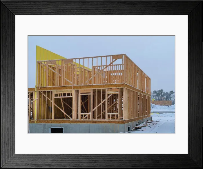 Framed Print : Building frame structure on a new development timber frame for a progressing house Framed Print : Building frame structure on a new development timber frame for a progressing house