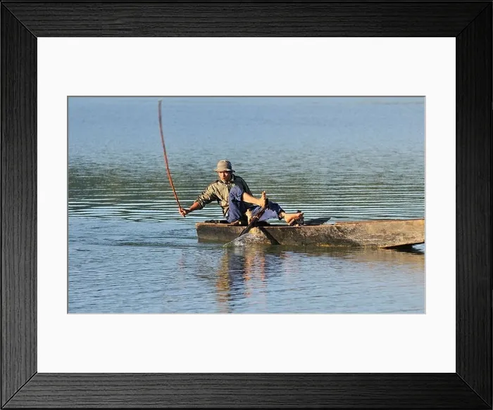 Framed Print : Fishermen in a wooden fishing boat using the traditional stick blow method Framed Print : Fishermen in a wooden fishing boat using the traditional stick blow method