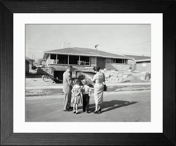 Framed Print : Rear view of a mature couple and their children standing in front of a house and looking at a blueprint Framed Print : Rear view of a mature couple and their children standing in front of a house and looking at a blueprint