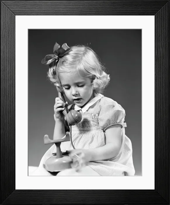 Framed Print : 1940S Little Blond Girl Talking On Toy Telephone Framed Print : 1940S Little Blond Girl Talking On Toy Telephone