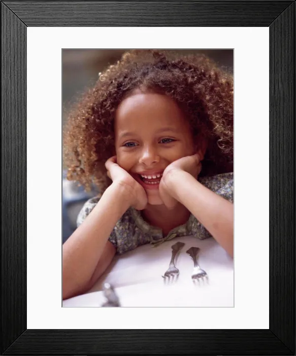 Framed Print : Close-up of a girl leaning on a dining table Framed Print : Close-up of a girl leaning on a dining table