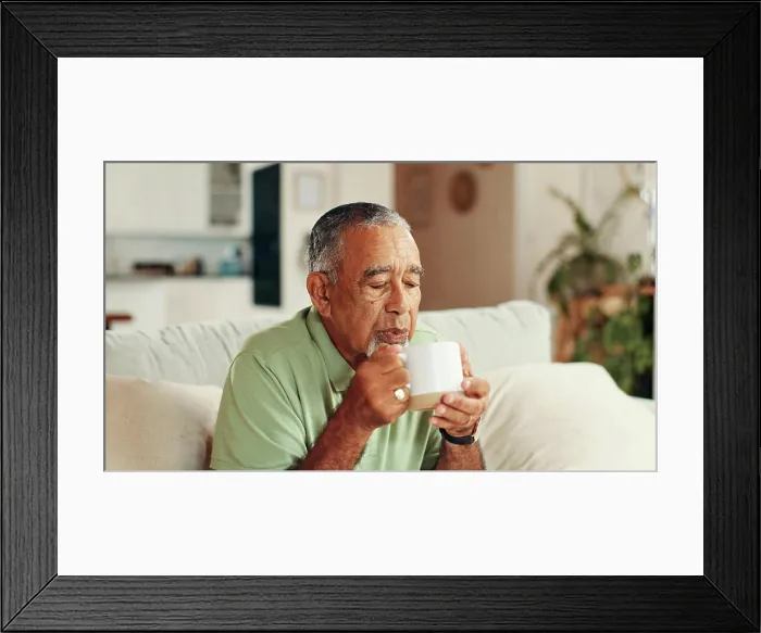 Framed Print : Home, coffee and senior man on sofa Framed Print : Home, coffee and senior man on sofa