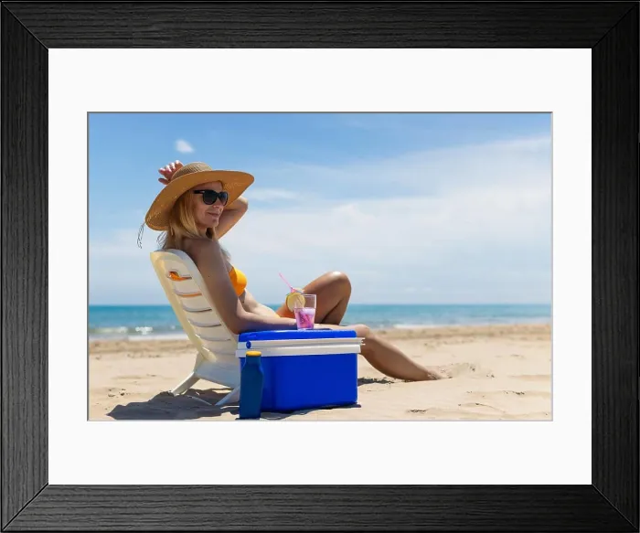 Framed Print : slender blonde in a bright bikini, sunglasses and is sunbathing on a sun lounger with a pink cocktail Framed Print : slender blonde in a bright bikini, sunglasses and is sunbathing on a sun lounger with a pink cocktail