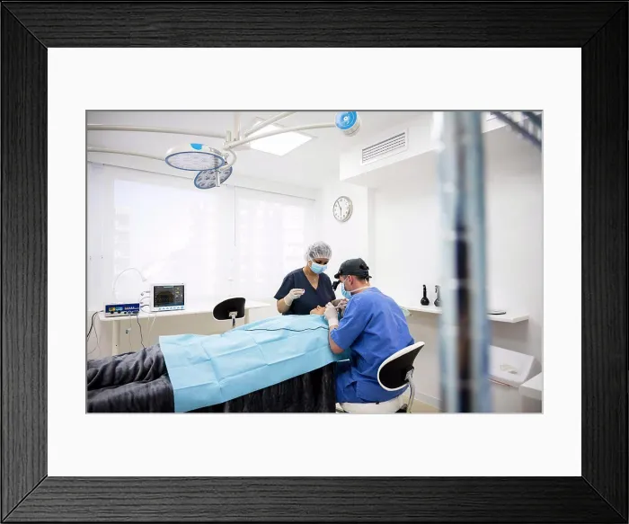 Framed Print : Surgeon sutures the eyelid after plastic surgery operation Framed Print : Surgeon sutures the eyelid after plastic surgery operation