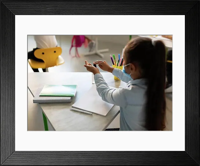 Framed Print : Back view girl disinfecting her hands