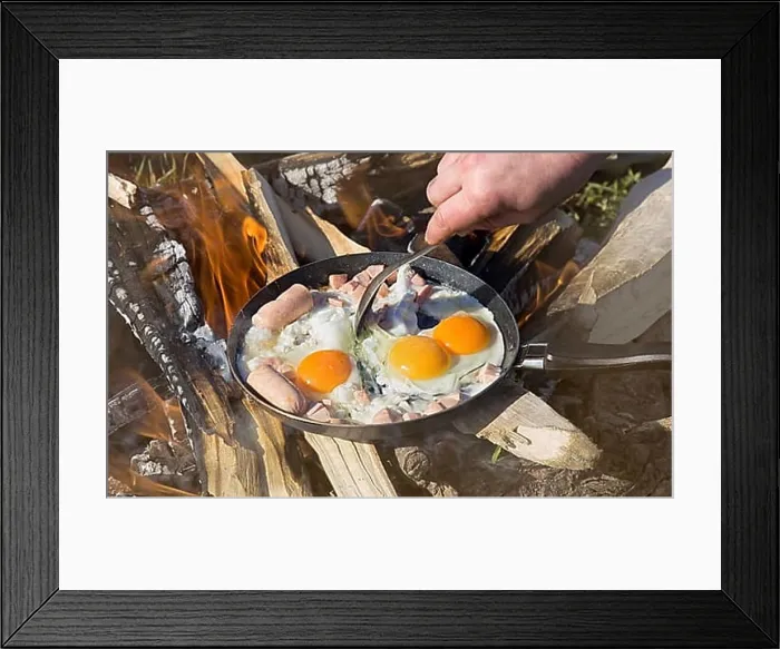Framed Print : Breakfast on nature of a picnic. scrambled egg fried on coals in a pan on fire Framed Print : Breakfast on nature of a picnic. scrambled egg fried on coals in a pan on fire