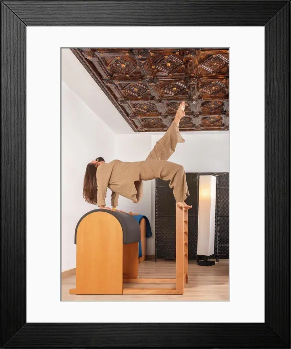 Framed Print : a brunette girl doing the bridge over barrel pilates pose with mask Framed Print : a brunette girl doing the bridge over barrel pilates pose with mask