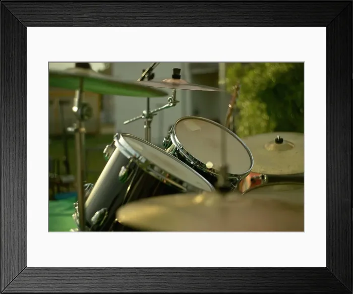 Framed Print : Drum set gleaming in the golden hour light, ready for a performance Framed Print : Drum set gleaming in the golden hour light, ready for a performance