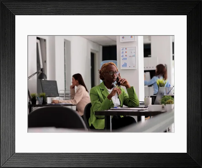 Framed Print : Employee talking on smartphone in coworking open space Framed Print : Employee talking on smartphone in coworking open space