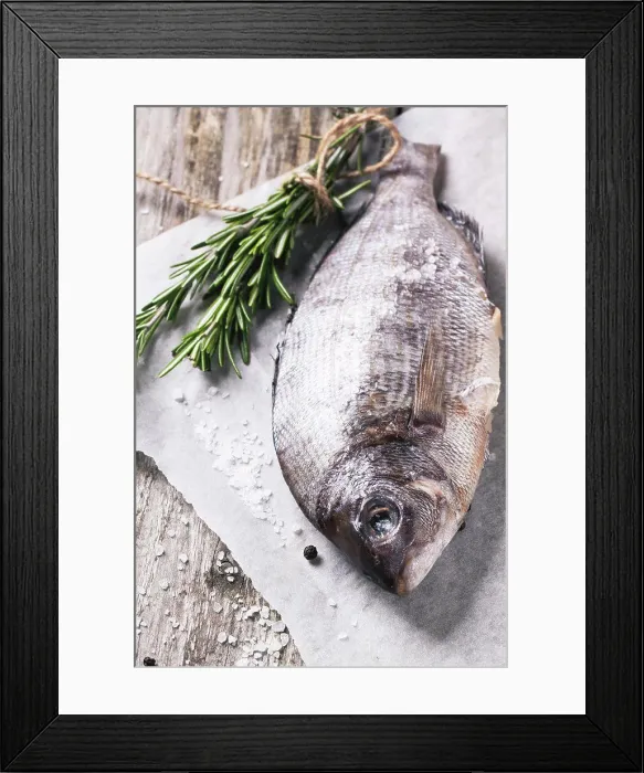 Framed Print : Raw dorado fish with rosemary and sea salt server on white paper over old wooden table Framed Print : Raw dorado fish with rosemary and sea salt server on white paper over old wooden table