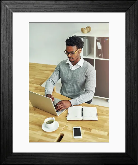 Framed Print : Business, black man and typing in office with laptop or journal for daily schedule or planning for time management