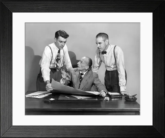 Framed Print : 1950s THREE BUSINESS MEN IN OFFICE STRATEGY CONFERENCE TWO STANDING ONE SEATED LOOKING AT PAPERS AND PLANS Framed Print : 1950s THREE BUSINESS MEN IN OFFICE STRATEGY CONFERENCE TWO STANDING ONE SEATED LOOKING AT PAPERS AND PLANS