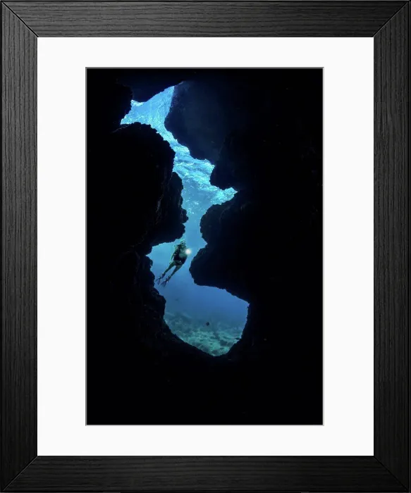 Framed Print : A diver (MR) shines her light into a crevice opening off Kaiwe Point on the Kona coast; Island of Hawaii Framed Print : A diver (MR) shines her light into a crevice opening off Kaiwe Point on the Kona coast; Island of Hawaii