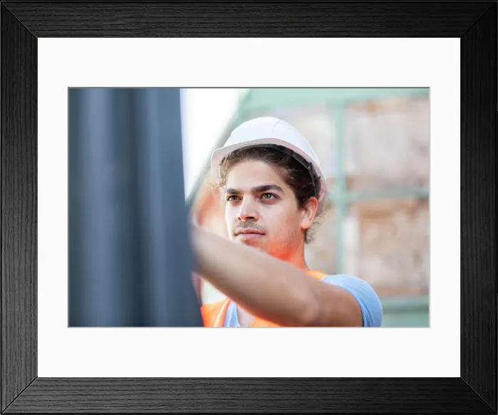 Framed Print : young construction engineer with helmet working outside