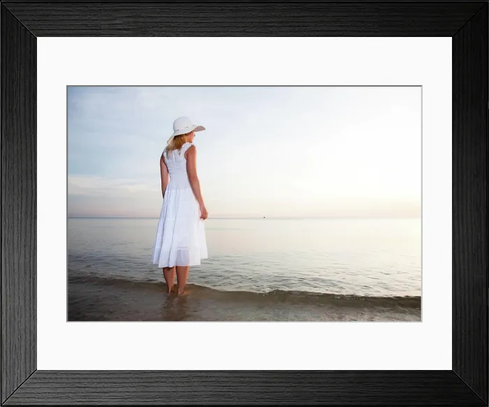 Framed Print : On the beach Woman in hat and white dress on the beach