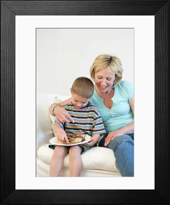 Framed Print : Mother and son eating biscuits