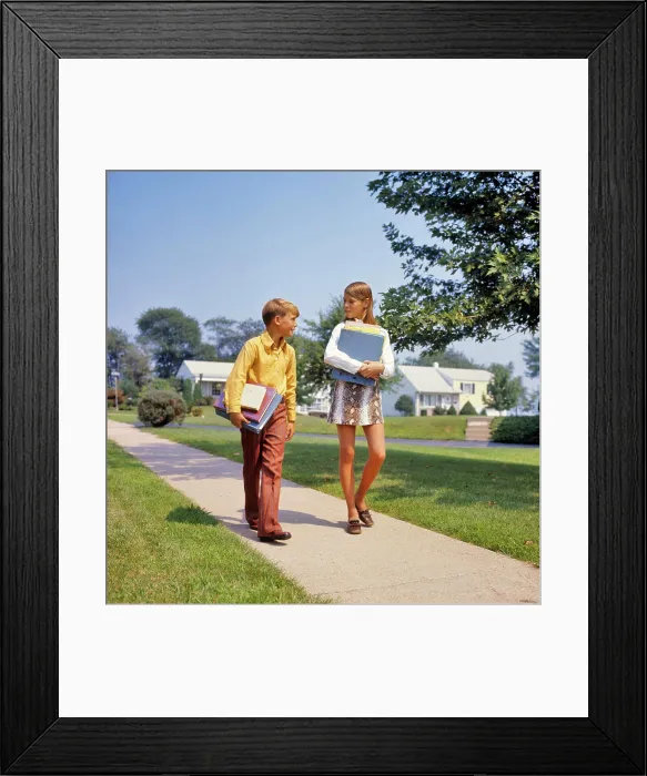Framed Print : 1960s 1970s BOY GIRL ON SIDEWALK WALKING HOME FROM OR TO SCHOOL TALKING CARRYING BOOKS GIRL WEARING FAUX SNAKESKIN MINI Framed Print : 1960s 1970s BOY GIRL ON SIDEWALK WALKING HOME FROM OR TO SCHOOL TALKING CARRYING BOOKS GIRL WEARING FAUX SNAKESKIN MINI
