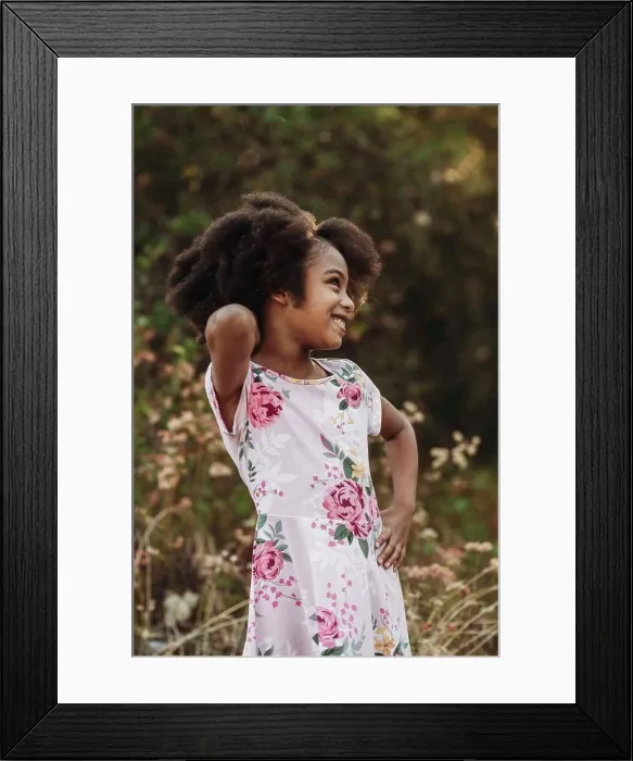 Framed Print : Portrait of young school-aged confident girl posing in field Framed Print : Portrait of young school-aged confident girl posing in field