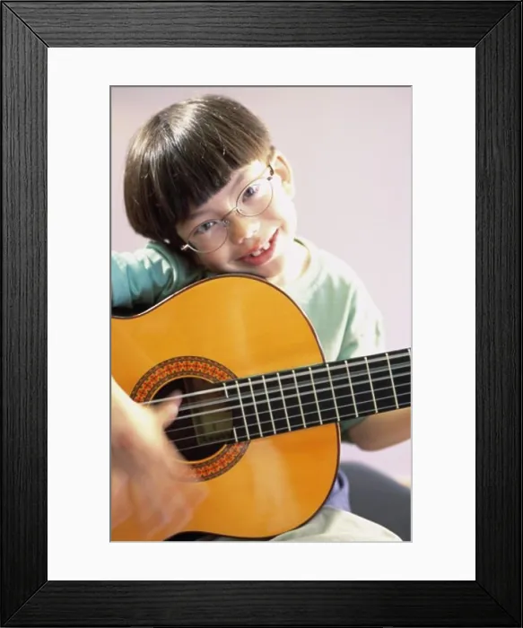 Framed Print : Portrait of a boy playing a guitar