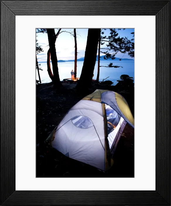 Framed Print : USA, Washington State, San Juan Islands, Cypress Island, Cypress Head. Man warms himself by campfire at dusk