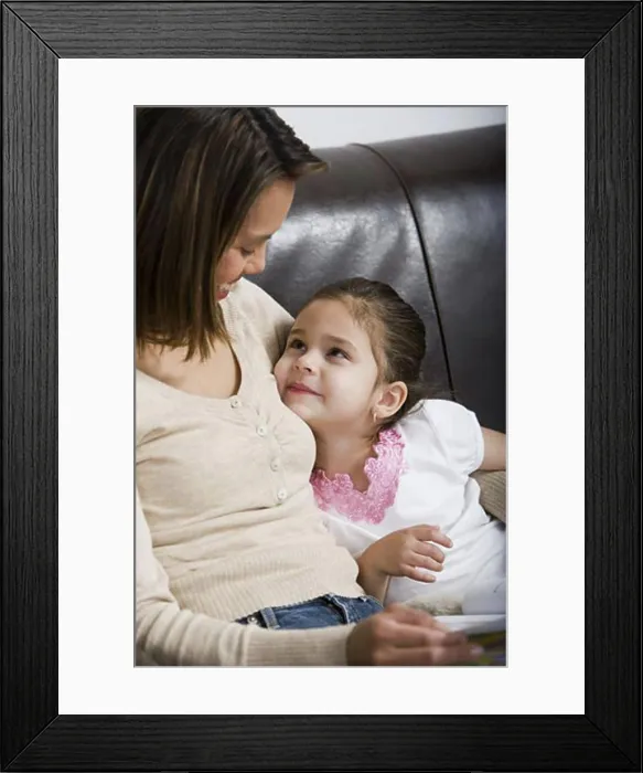 Framed Print : Mother and young daughter snuggling Framed Print : Mother and young daughter snuggling