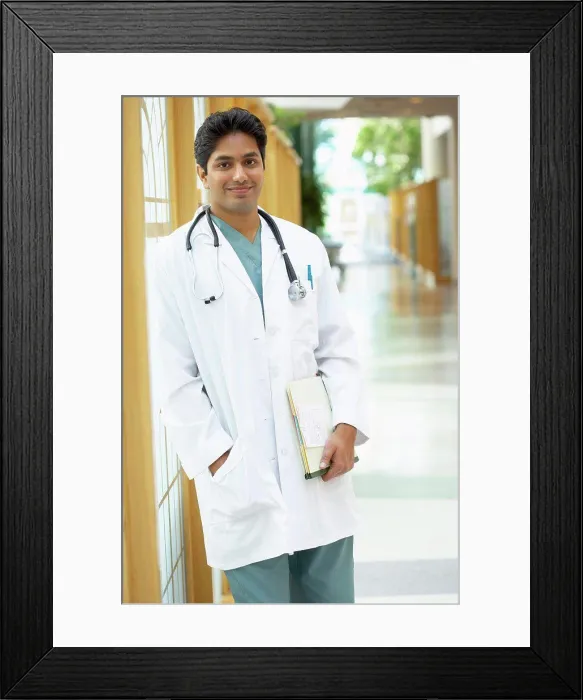 Framed Print : Male doctor standing in a corridor Framed Print : Male doctor standing in a corridor