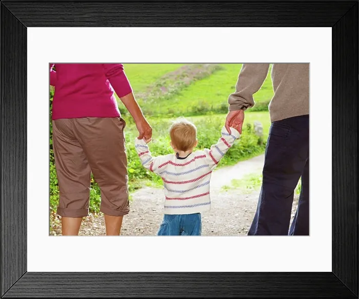 Framed Print : Senior couple walking with child Framed Print : Senior couple walking with child