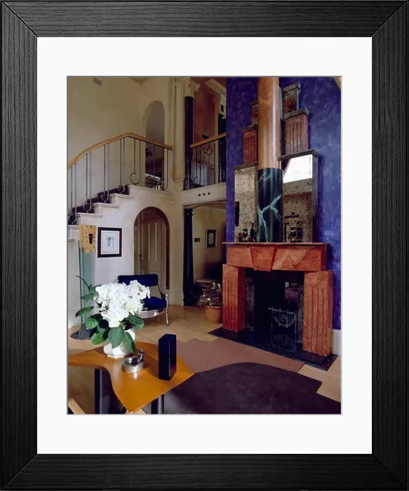 Framed Print : Neoclassical marbled red fireplace on blue wall in large hall with modern table and patterned wooden flooring Framed Print : Neoclassical marbled red fireplace on blue wall in large hall with modern table and patterned wooden flooring