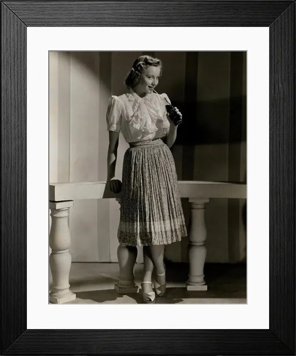 Framed Print : Studio shot of fashion model in casual clothing drinking soda Framed Print : Studio shot of fashion model in casual clothing drinking soda