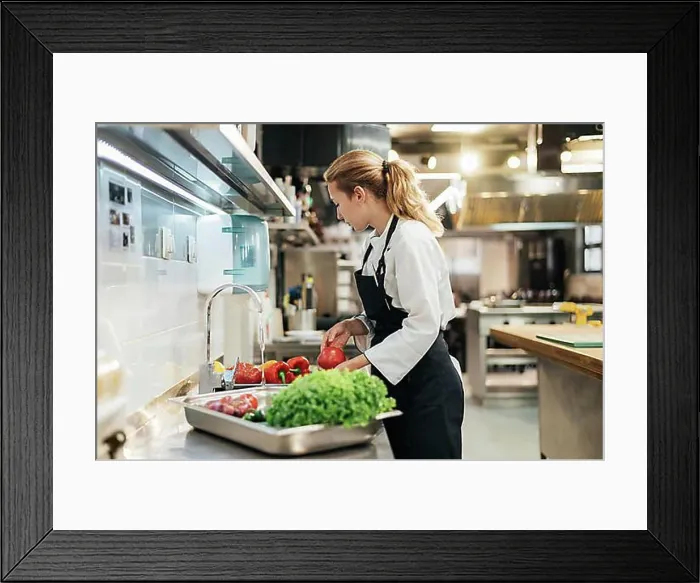 Framed Print : Side view female chef washing vegetables kitchen Framed Print : Side view female chef washing vegetables kitchen