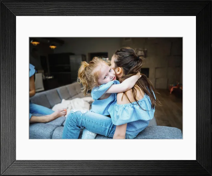 Framed Print : Elder and younger daughter on the big couch Elder and younger daughter posing together on the big couch at the camera Framed Print : Elder and younger daughter on the big couch Elder and younger daughter posing together on the big couch at the camera