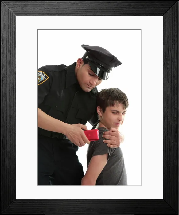 Framed Print : Police officer with teen uvenile delinquent A policeman with a male juvenile delinquent that has stolen an electronic Framed Print : Police officer with teen uvenile delinquent A policeman with a male juvenile delinquent that has stolen an electronic