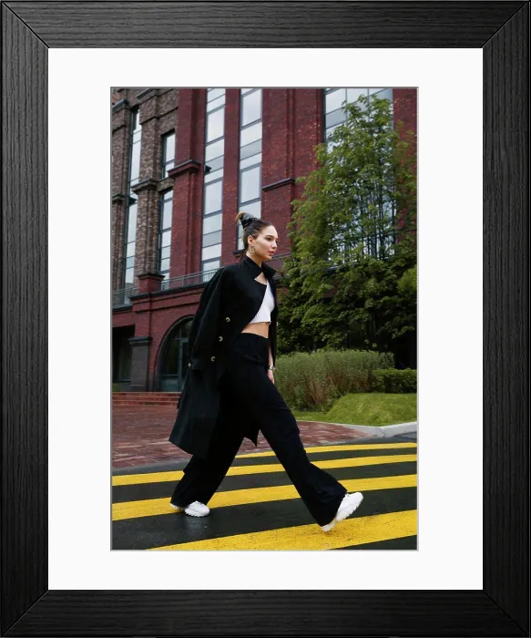 Framed Print : Young woman walking on a pedestrian crossing in the street Framed Print : Young woman walking on a pedestrian crossing in the street