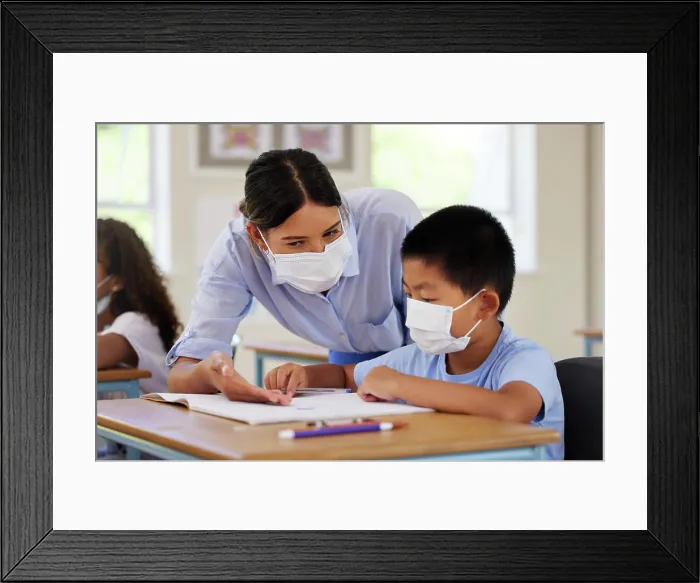 Framed Print : Covid, students and education teacher helping learning children in school classroom to answer math question
