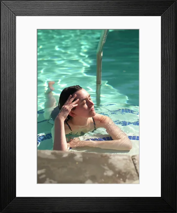 Framed Print : Woman relaxing in a pool, basking in sunlight with eyes closed, hand on forehead. Palm Springs, USA Framed Print : Woman relaxing in a pool, basking in sunlight with eyes closed, hand on forehead. Palm Springs, USA