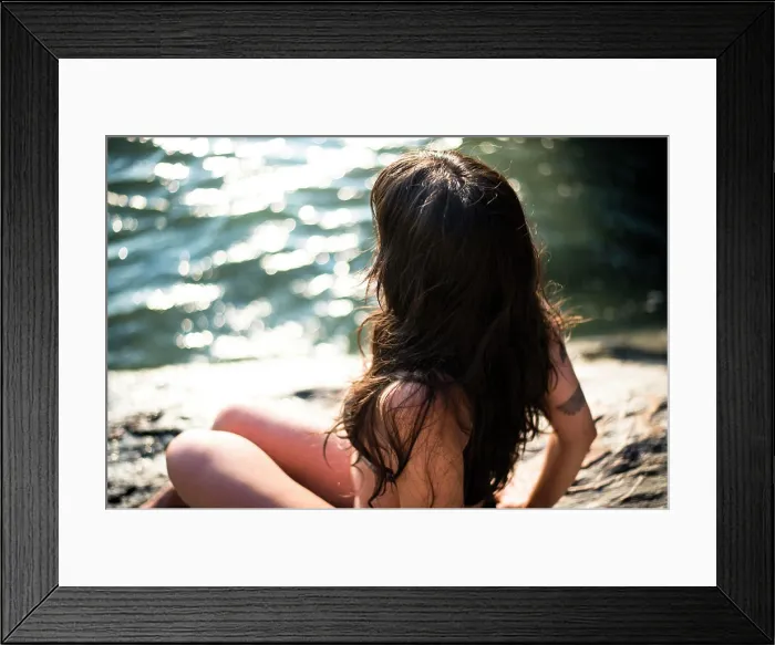 Framed Print : Young Latina Woman sitting by the ocean at golden hour in summertime