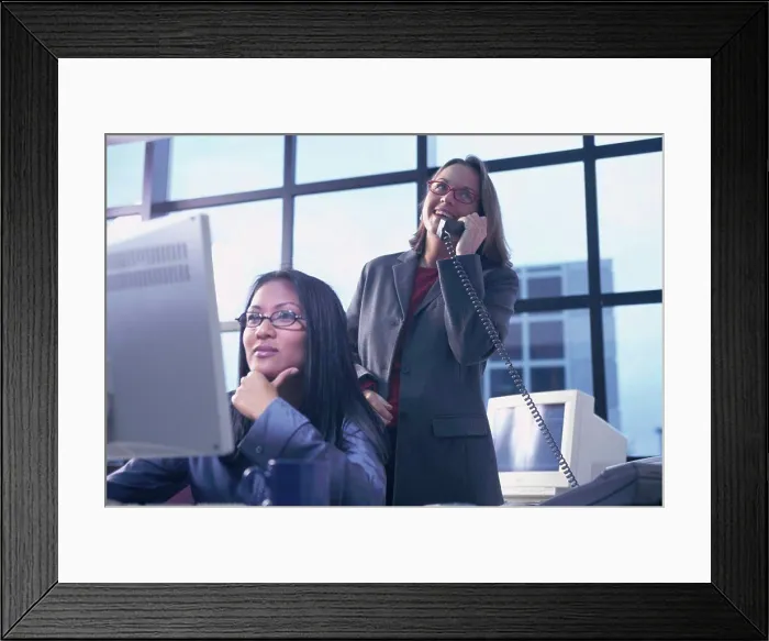 Framed Print : Two businesswomen working in an office Framed Print : Two businesswomen working in an office