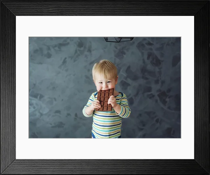 Framed Print : Portrait of an littel boy eating chocolate Portrait of an adorable baby eating chocolate Framed Print : Portrait of an littel boy eating chocolate Portrait of an adorable baby eating chocolate
