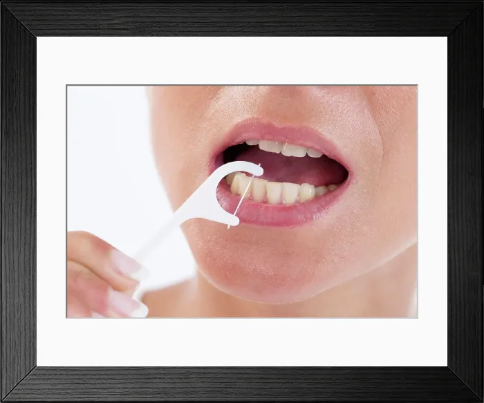 Framed Print : Woman using dental floss Framed Print : Woman using dental floss
