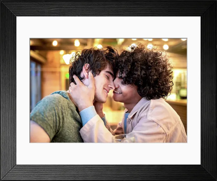 Framed Print : Side view of excited ethnic men embracing each other with closed eyes on table Framed Print : Side view of excited ethnic men embracing each other with closed eyes on table
