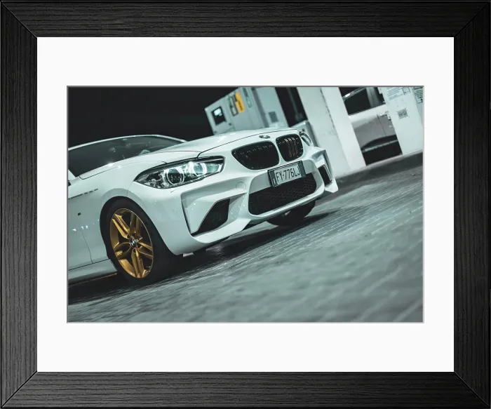 Framed Print : Adria, Italy 30 july 2024: View of a BMW Series 1 with gold wheels parked at night Framed Print : Adria, Italy 30 july 2024: View of a BMW Series 1 with gold wheels parked at night