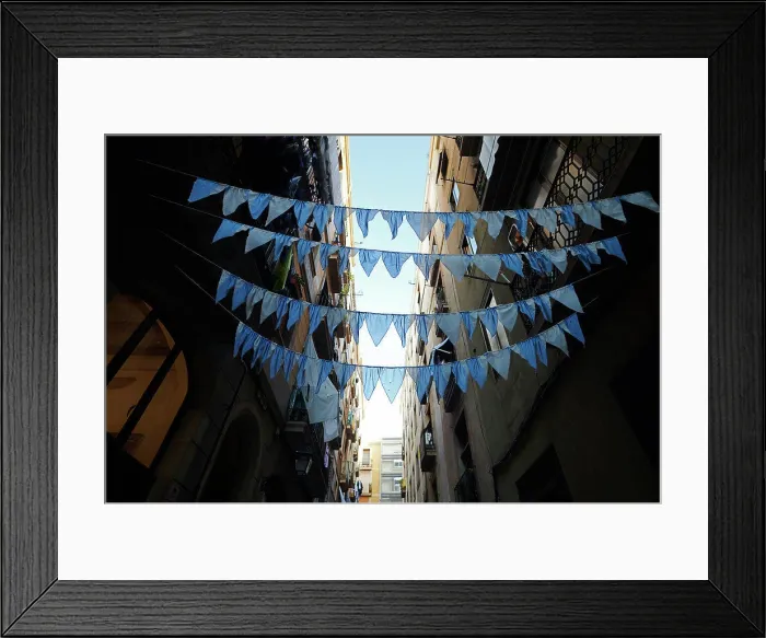 Framed Print : Blue garlands spanned across a street Framed Print : Blue garlands spanned across a street