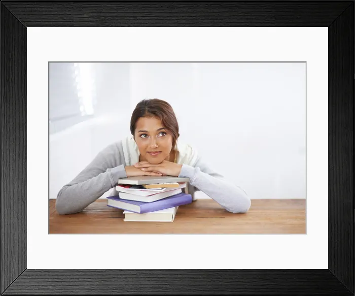 Framed Print : Student, happy and thinking with books by desk Framed Print : Student, happy and thinking with books by desk