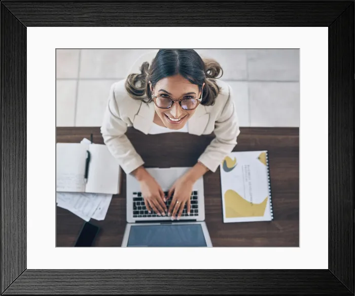 Framed Print : Top view, portrait or business woman on laptop in company finance management Framed Print : Top view, portrait or business woman on laptop in company finance management