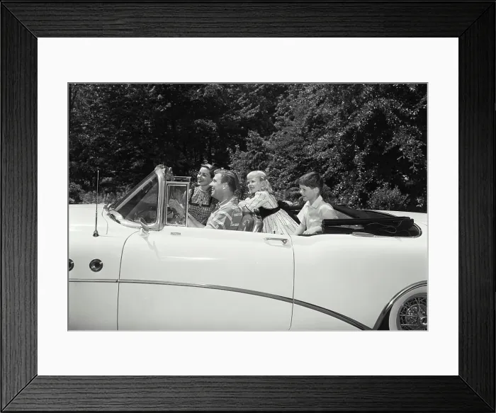 Framed Print : Parents and their children traveling in a car