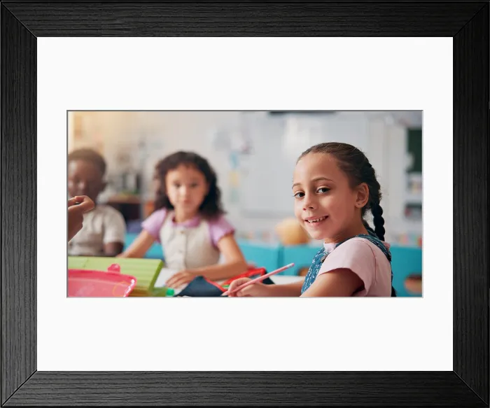 Framed Print : Portrait, education and writing with girl in classroom for child development Framed Print : Portrait, education and writing with girl in classroom for child development