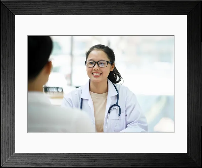 Framed Print : Doctor talking to a patient at medical clinic Framed Print : Doctor talking to a patient at medical clinic