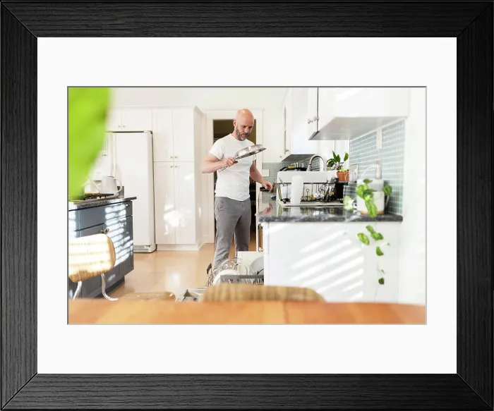 Framed Print : Loading dishes in a sunny white kitchen